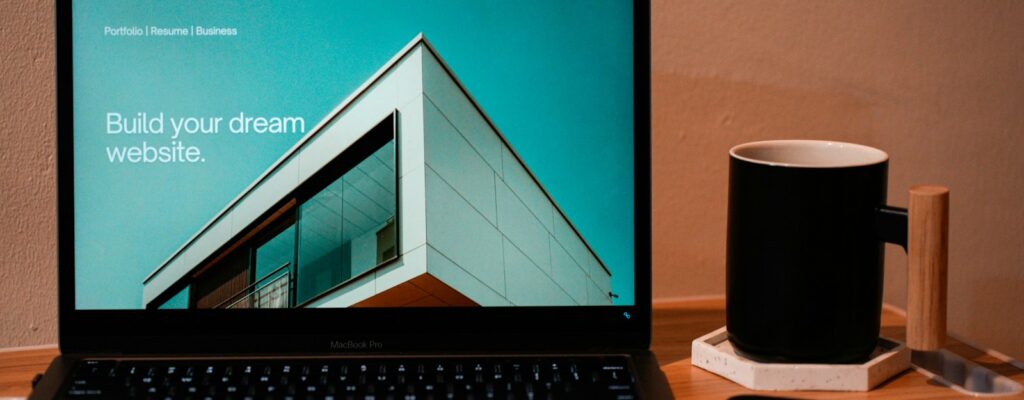 a laptop computer sitting on top of a wooden desk